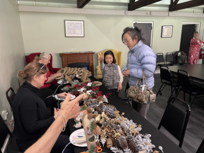 People at a wreath making table