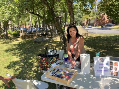 Woman at the face painting table