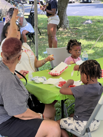 Family sitting around a table eating food