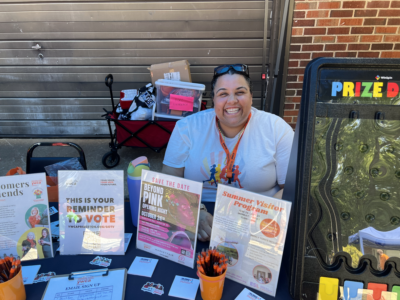 Woman behind the YWCA table with prizes
